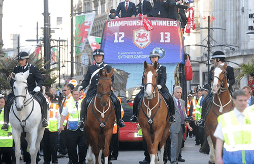 Police horses leading a football parade